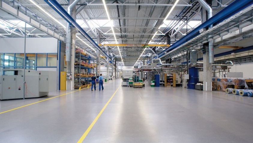 Wide industrial production hall with seamless coated flooring